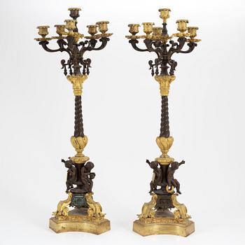 A pair of patinated bronze and ormolu neo-renaissance six-light candelabra, later part of the 19th Century.