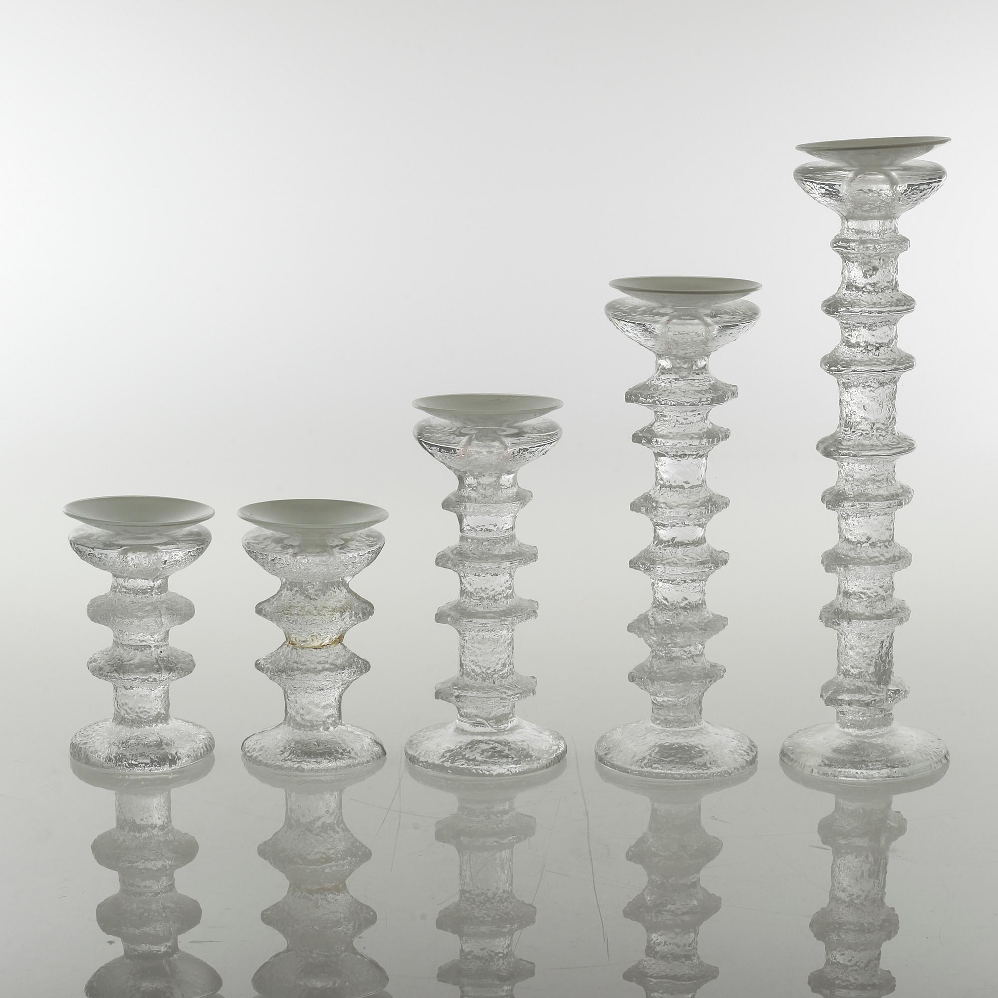Five glass candlesticks by Timo Sarpaneva for Iittala, model "Festivo", second half of the 20th century.