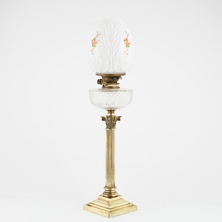 A brass and glass column shaped paraffin lamp, end of the 19th Century.