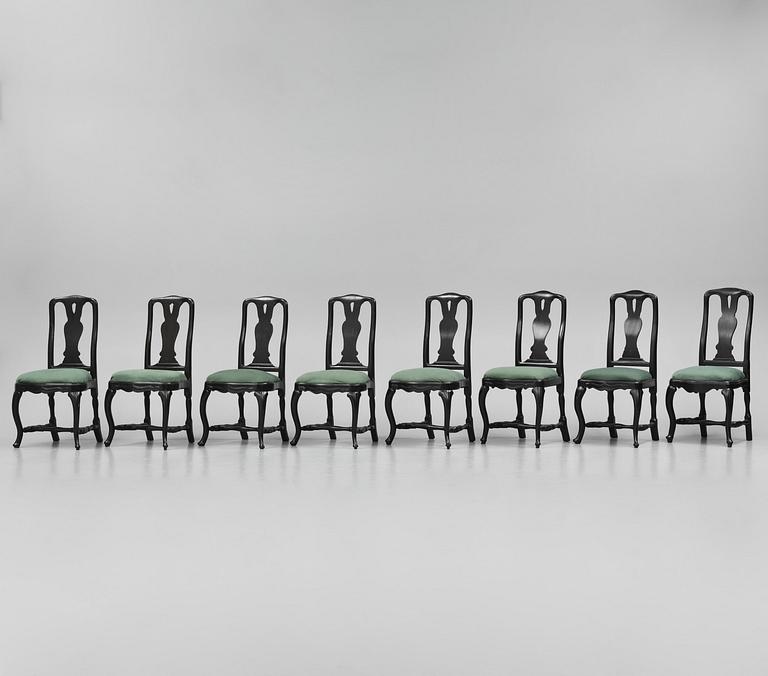 A set of eight black Swedish rococo chairs.