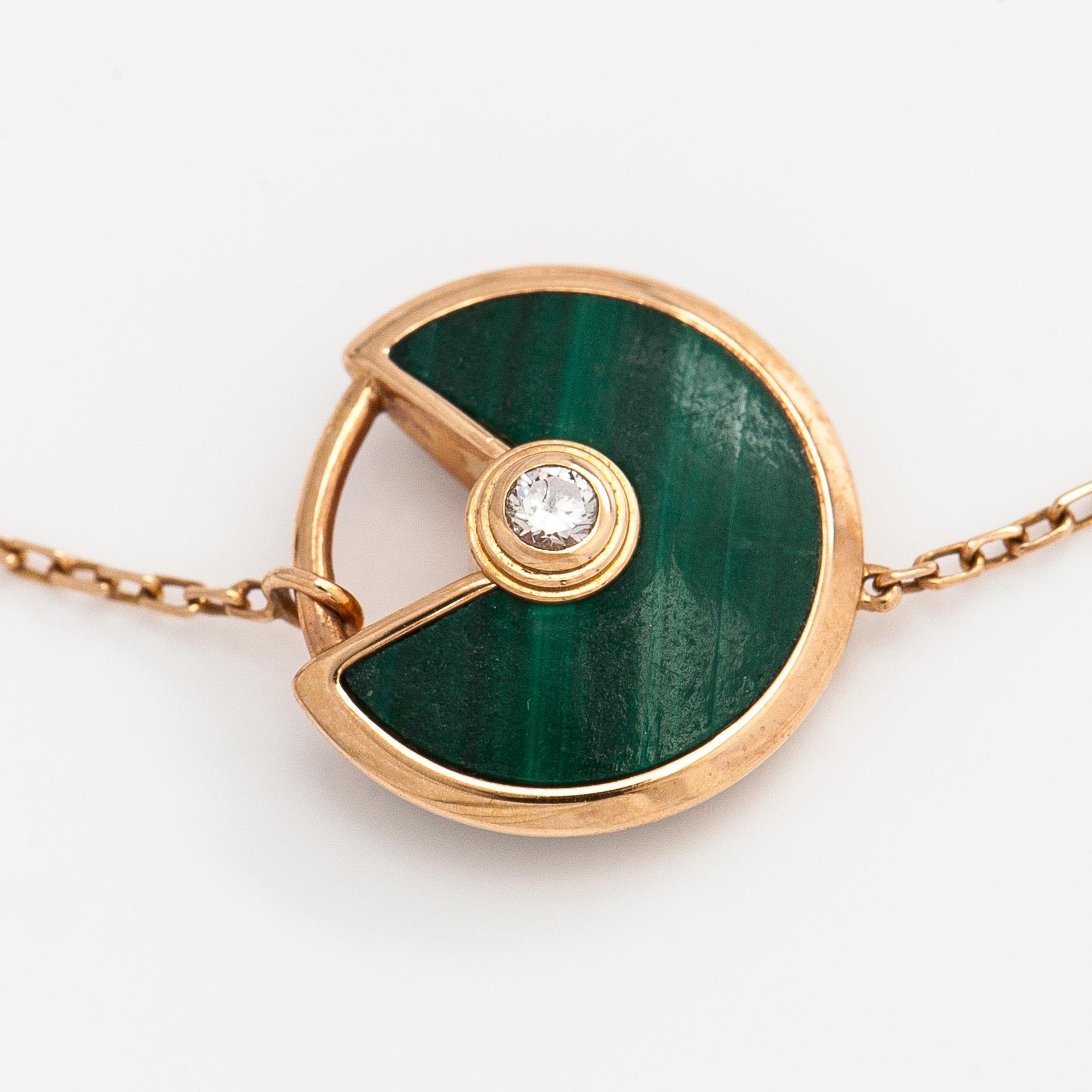Cartier, an 18K gold "Amulette de Cartier" bracelet with malachite and a brilliant-cut diamond.