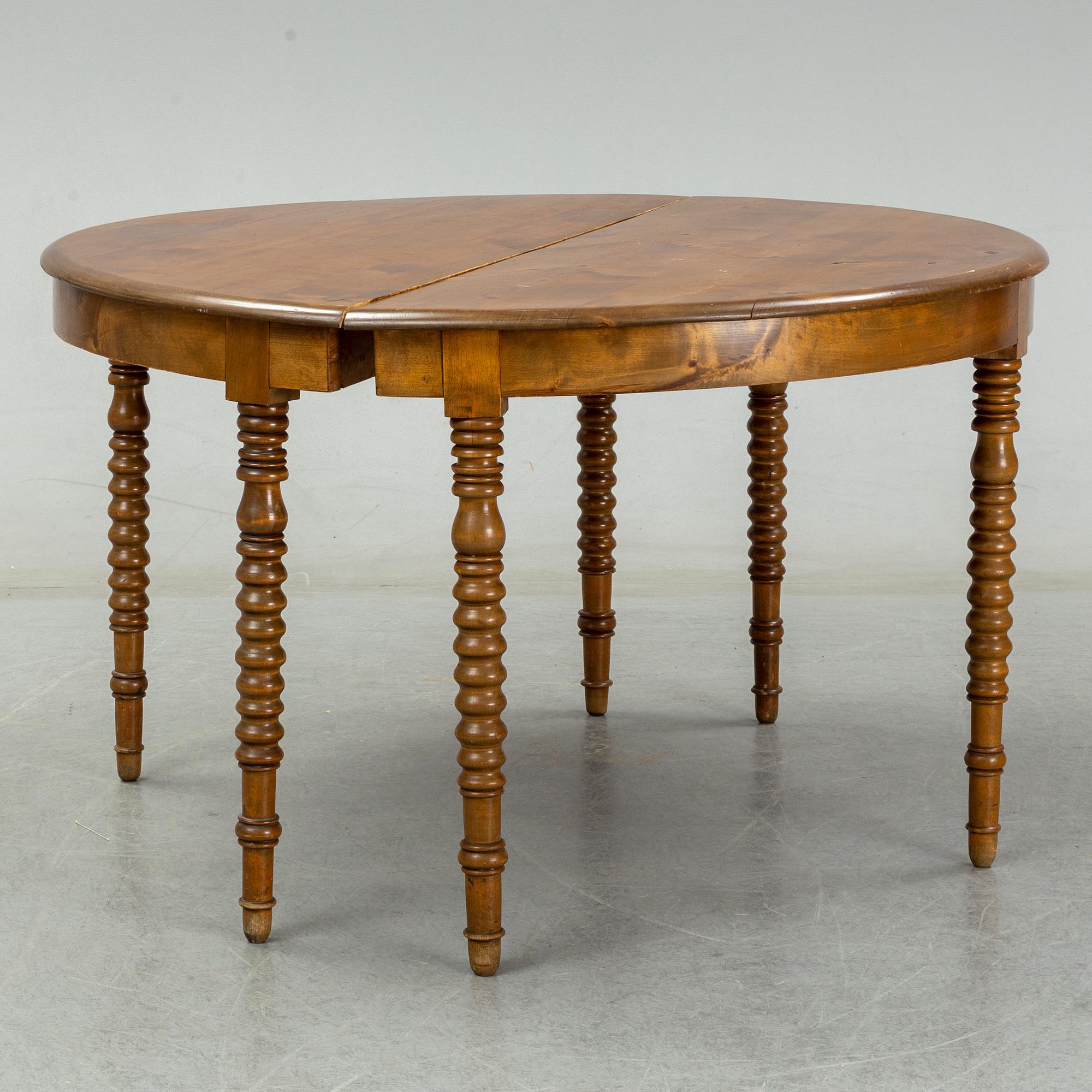 A two-piece birch dining table from around the year 1900.