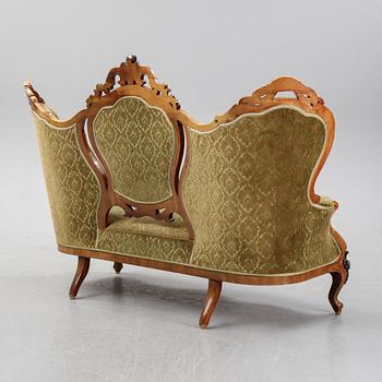 A rococo style sofa, four chairs and a table, second half of the 19th Century.