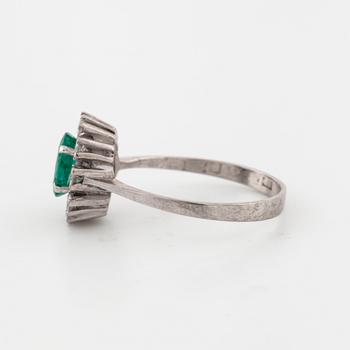 A emerald and brilliant cut diamond ring.