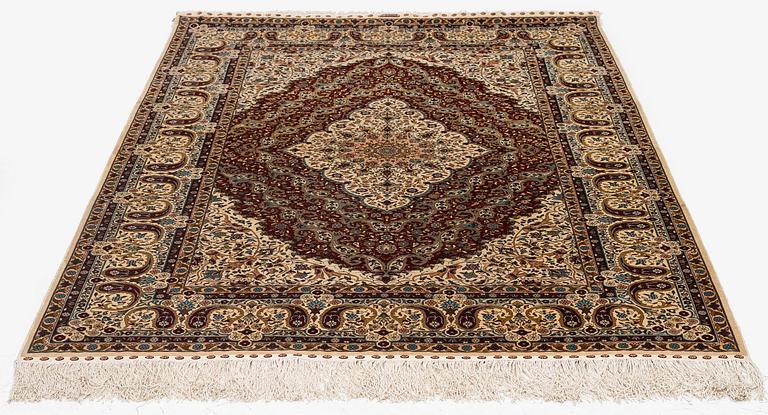 A semi-antique silk Hereke rug, West Anatolia, c. 180 x 121 cm.