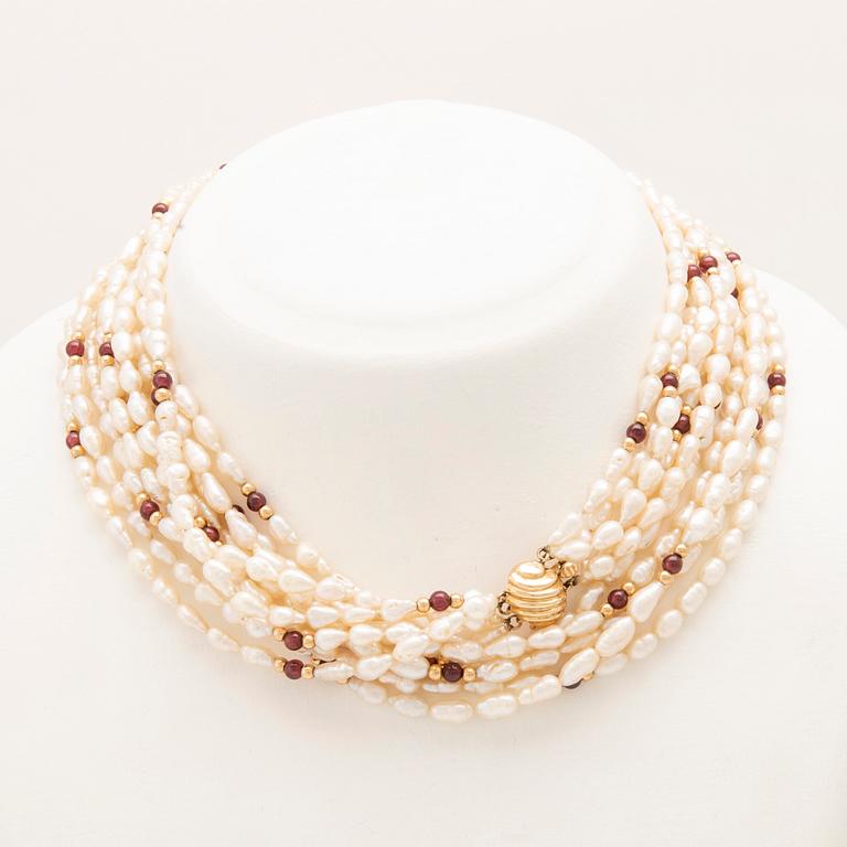 Multi-strand necklace with clasp and beads in 14K gold, cultured pearls, and garnet beads.