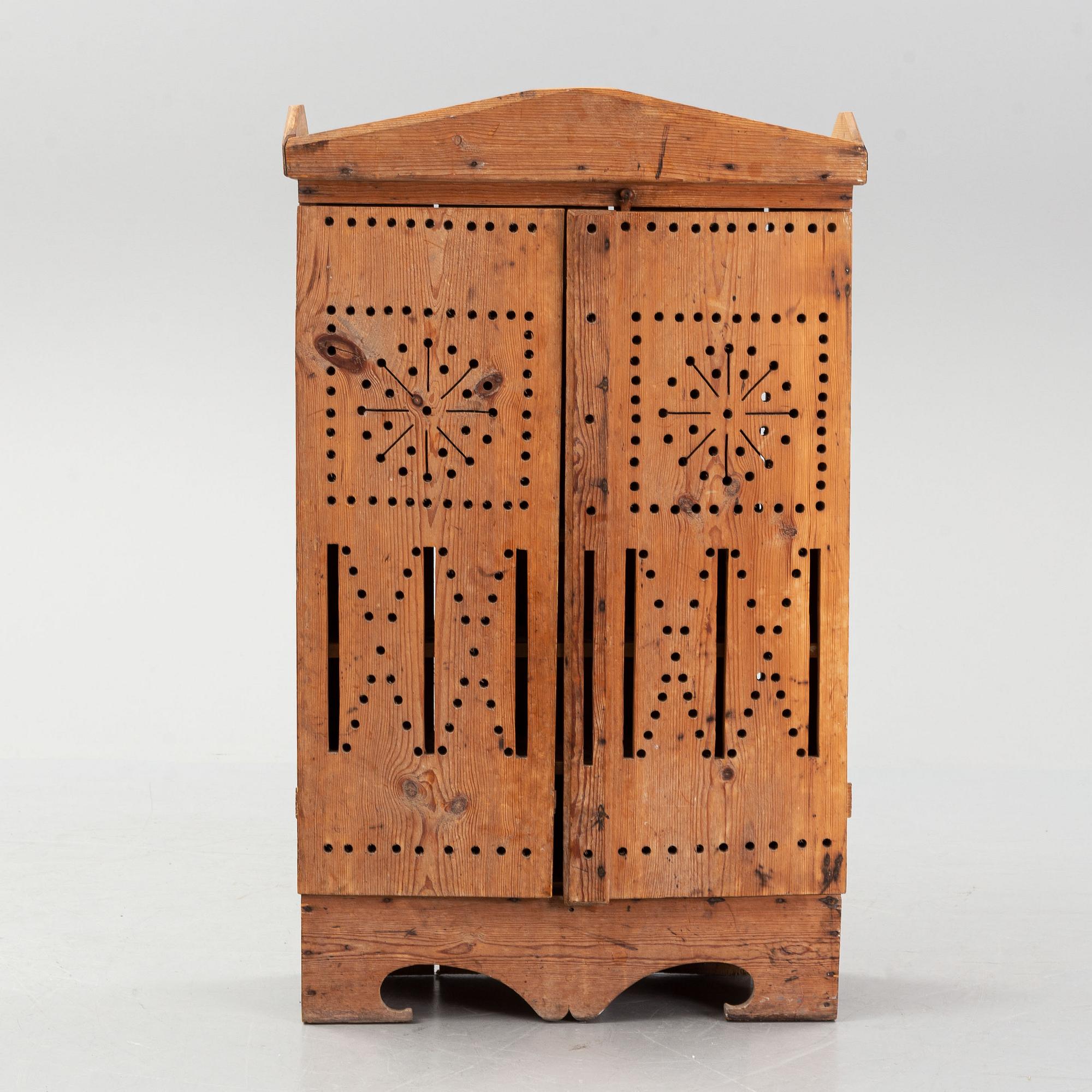 A late 19th century pine cupboard for eggs.