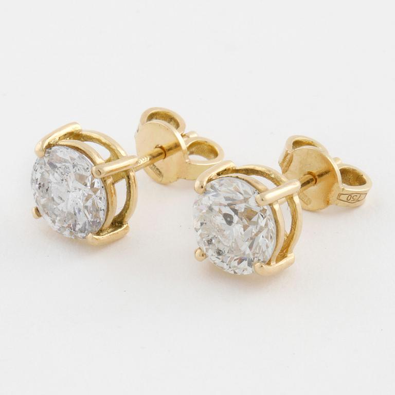 A pair of brilliant cut diamond earrings.