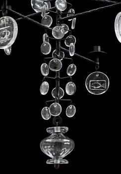 An Erik Höglund iron and cast glass chandelier for twelve candles, Boda Smide, Sweden.