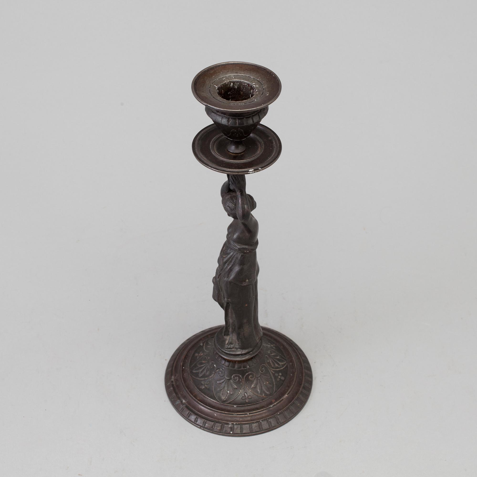 A 19th century iron candlestick marked F.L Vombach Offenbach A/M.