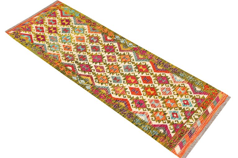 An Afghan kilim rug, c. 246 x 80 cm.