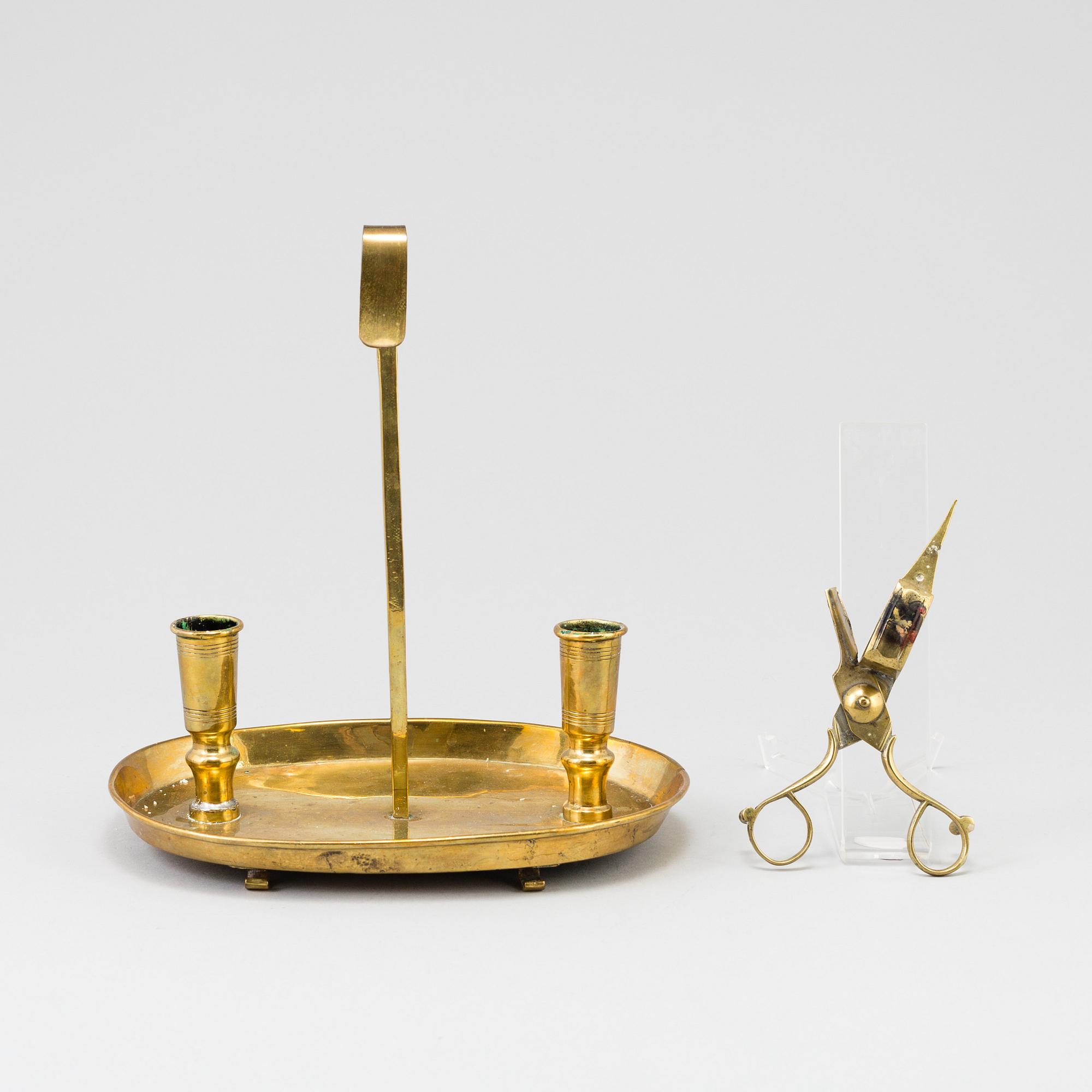 A 19th century bra candleholder for two candles and candle wick-trimming scissors.