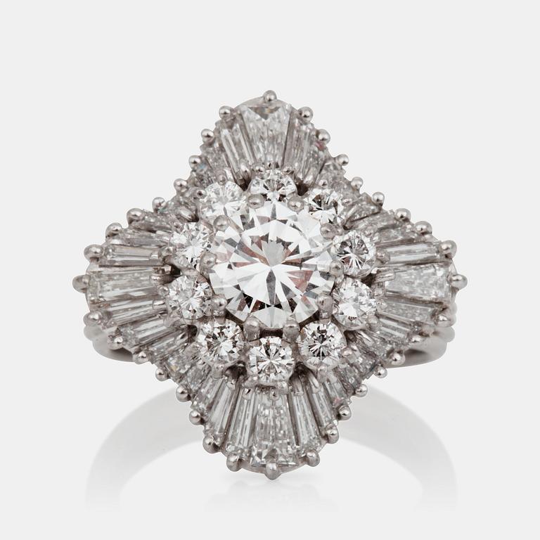 A brilliant- and trapezoid-cut diamond ring. Center diamond circa 1.10 cts and surrounding diamonds circa 1.00 ct.