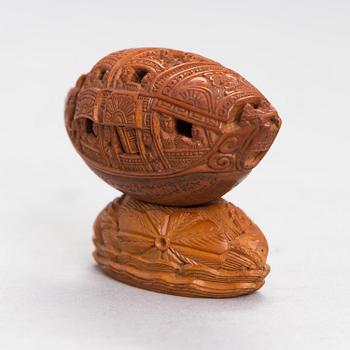 A Chinese nut boat sculpture, with poem.