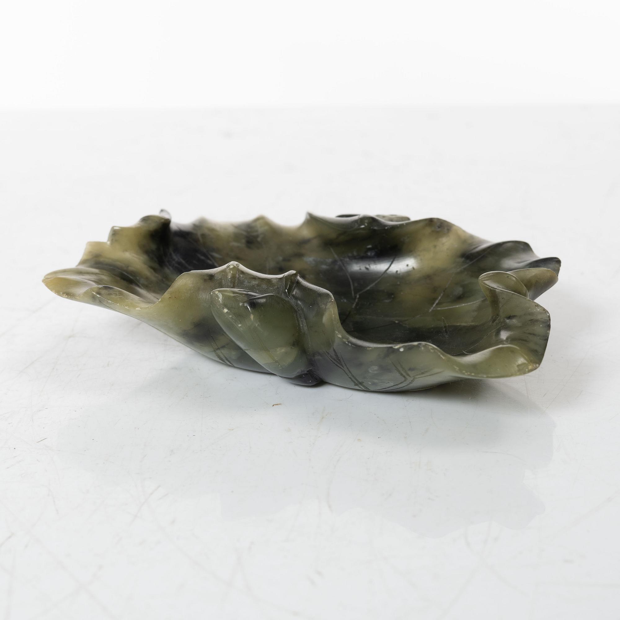 A Chinese green stone brush washer, a carved bone and a soapstone figure, partly Qing dynasty.