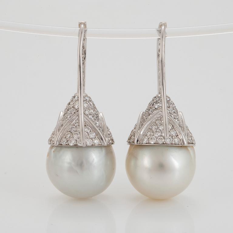 A pair of cultured South Sea pearl and diamond earrings.