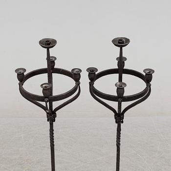 a pair of iron floor candle sticks, 20th century.