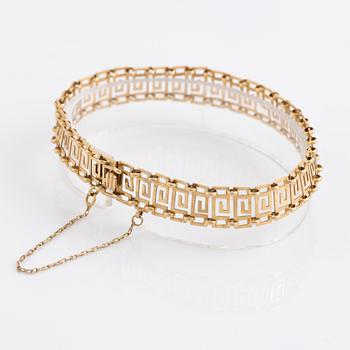 Armband samt ring, guld, dekor av meanderbård.