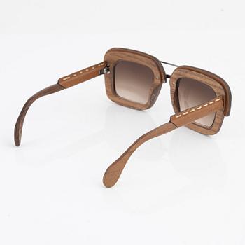 Prada, a pair of wood and leather sunglasses.