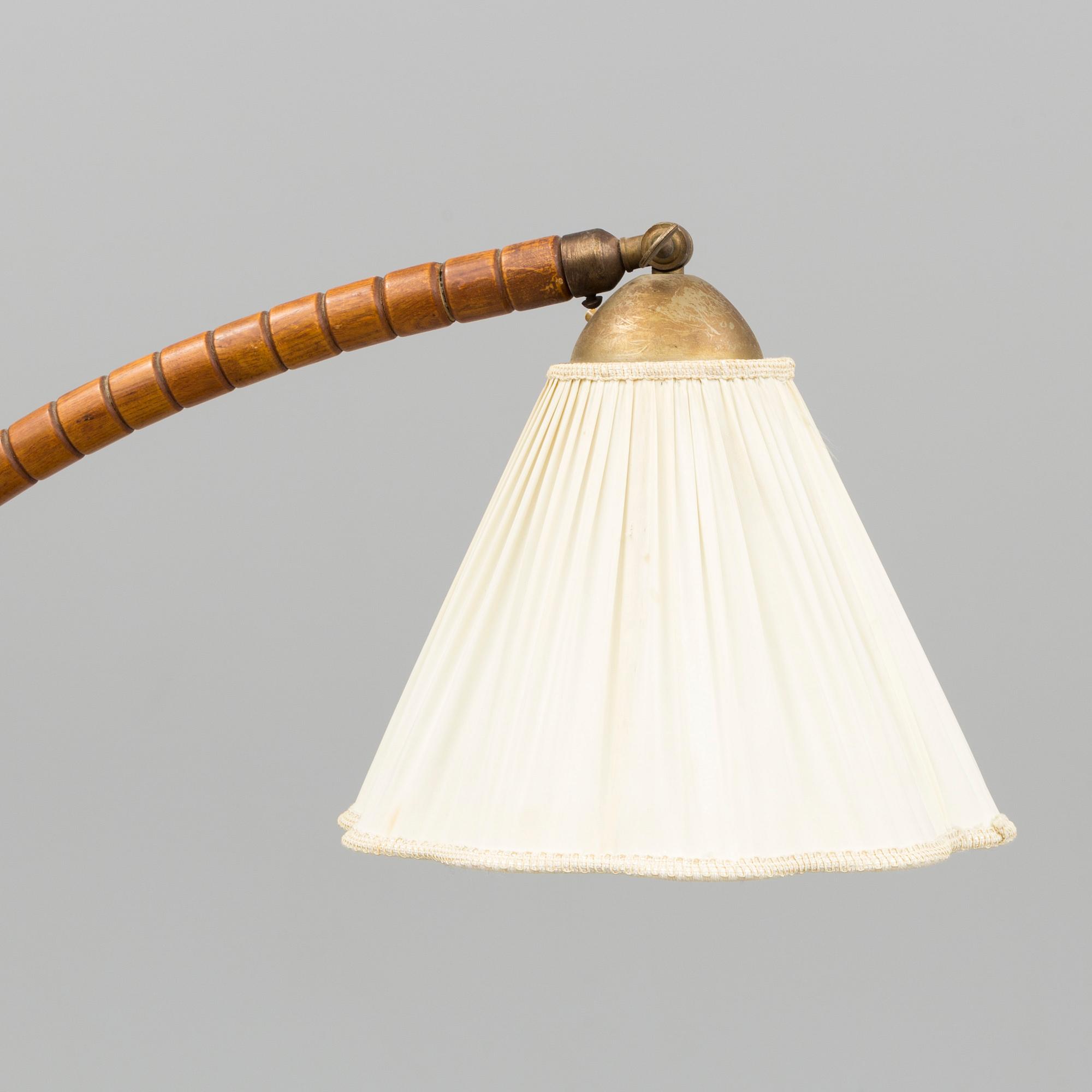 A first half of the 20th century floor lamp with table.