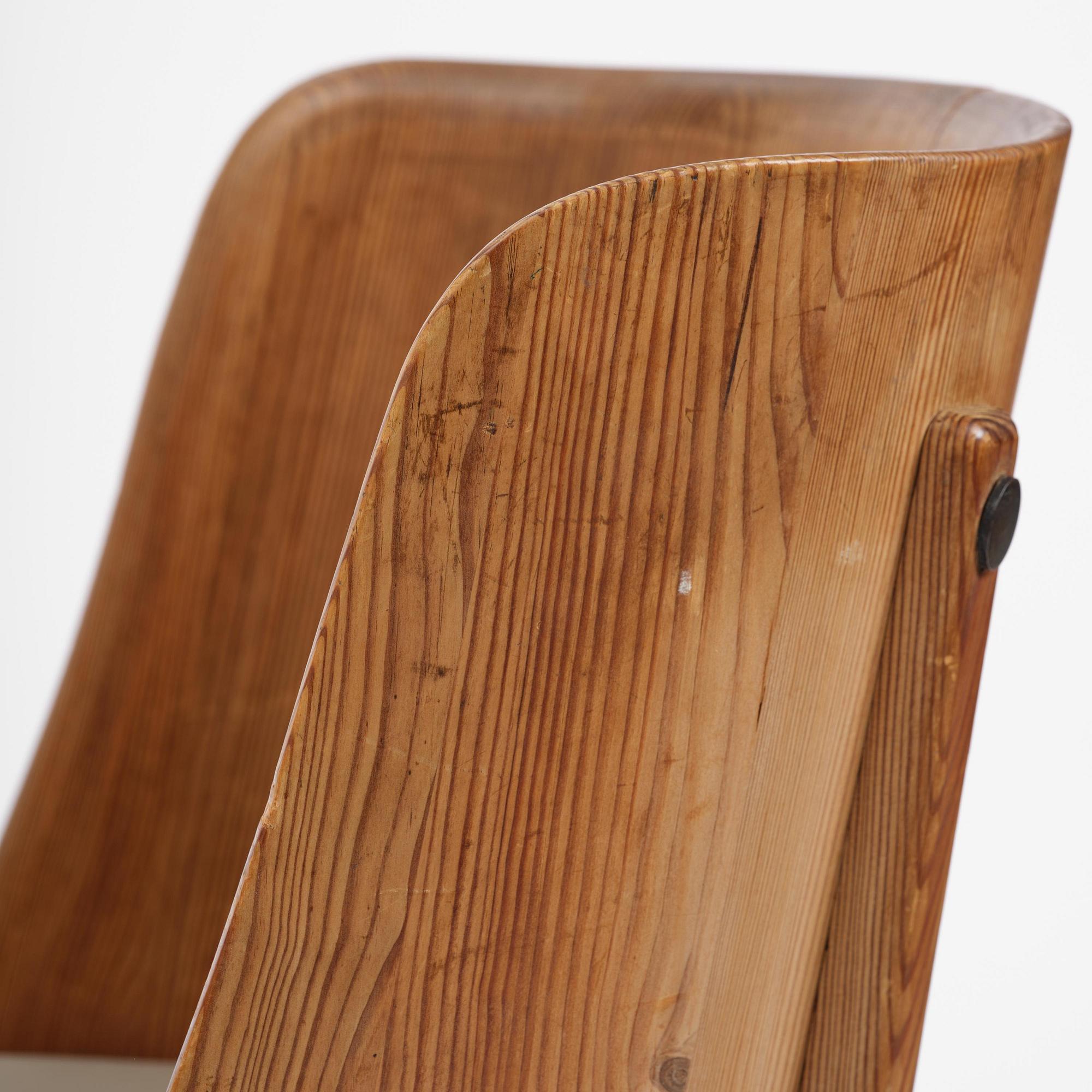 Axel Einar Hjorth, a pair of stained pine "Lovö" armchairs, Nordiska Kompaniet, Sweden, 1930s.