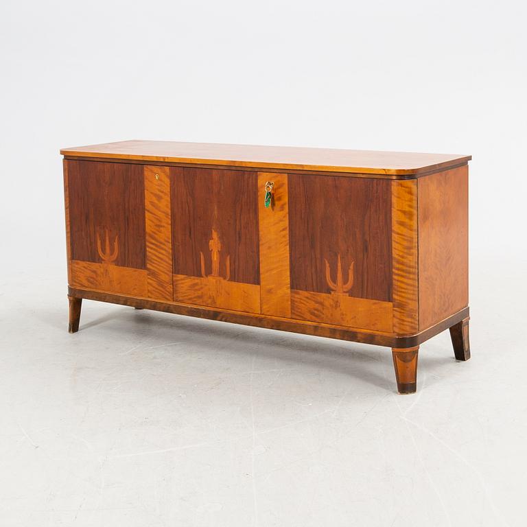 A 1940s walnut, birch and mahogany sideboard.