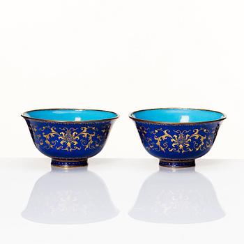 A pair of gilt decorated blue ground painted enamel bowls, Qianlong four character seal mark and period (1736-95).