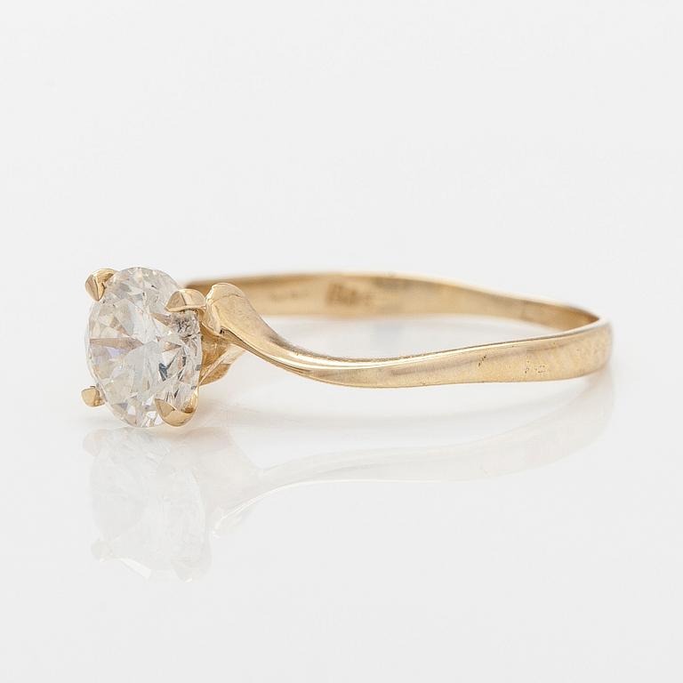 A 14K gold ring with brilliant cut diamond.