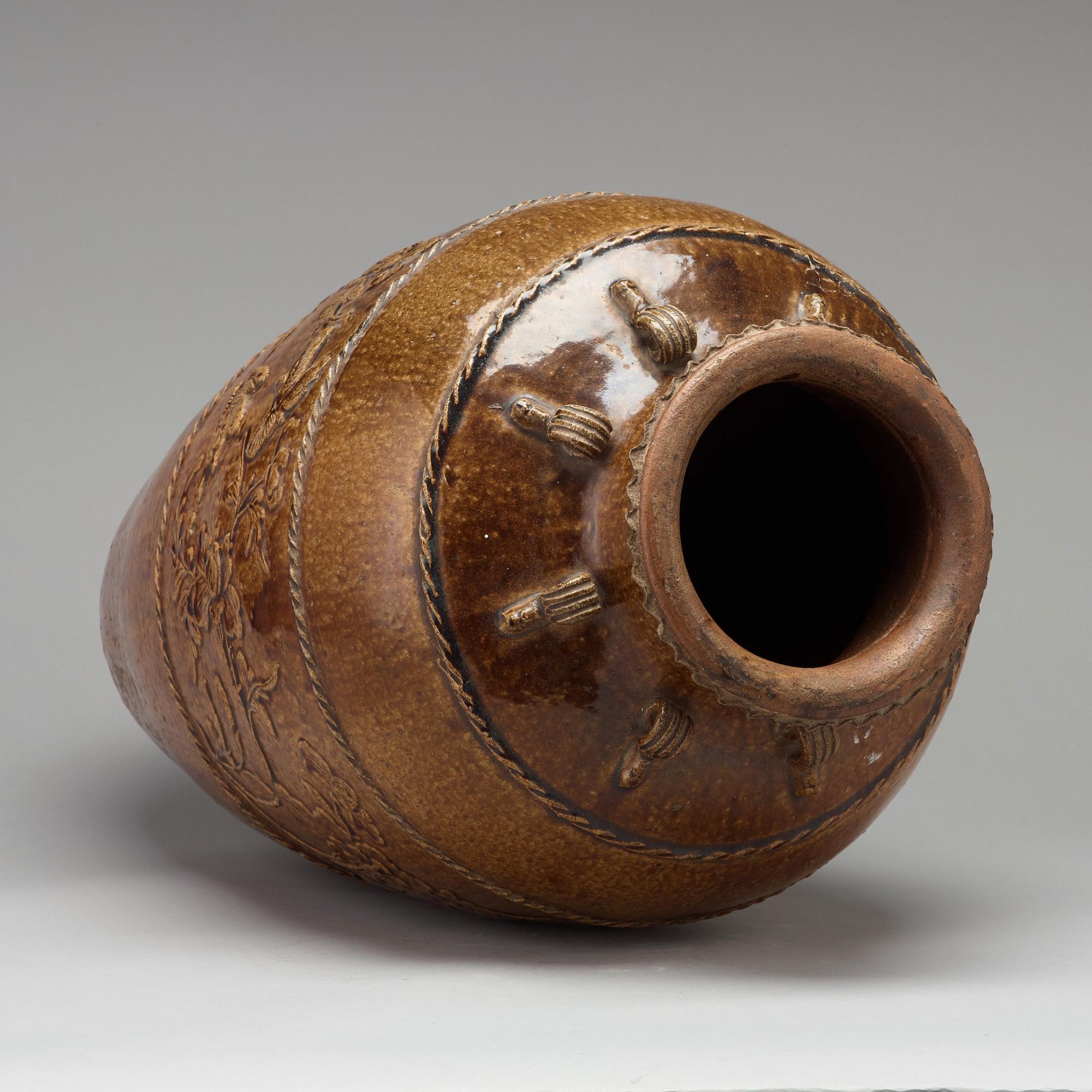A large brown glazed Martaban jar, presumably 18th Century.