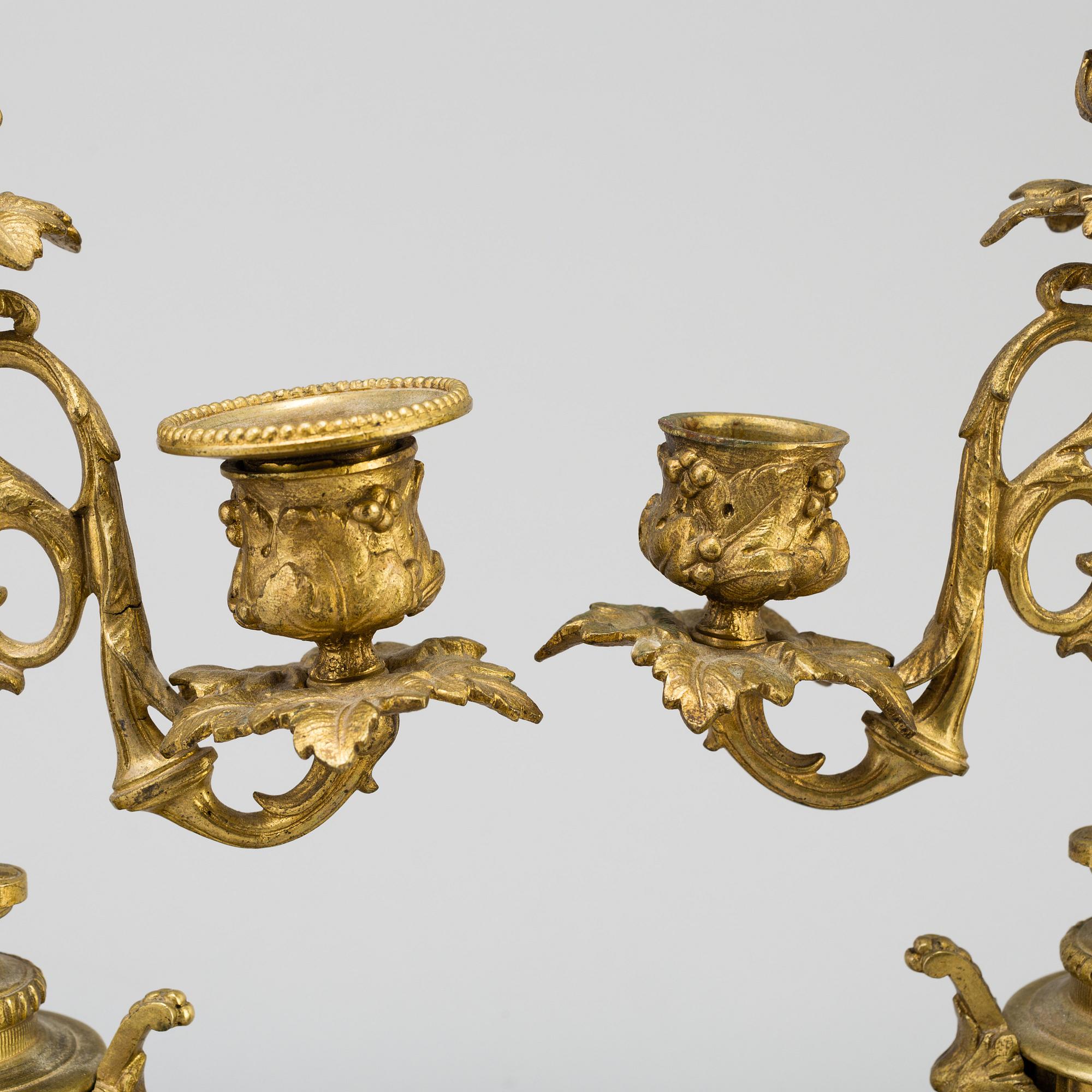A table CLOCK and a pair of candelabra, second part of 19th century.