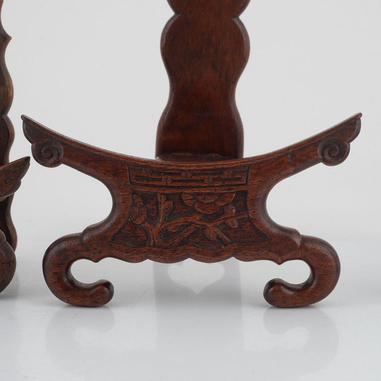 Seven hardwood stand for plates and vase, and one lid, China, 20th century.