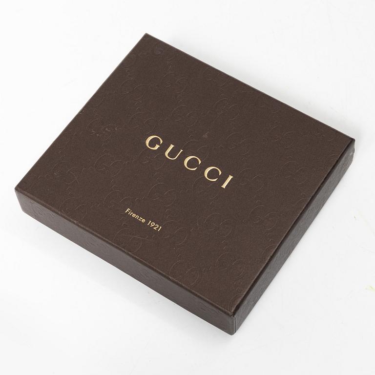 Gucci, wallet and belt.