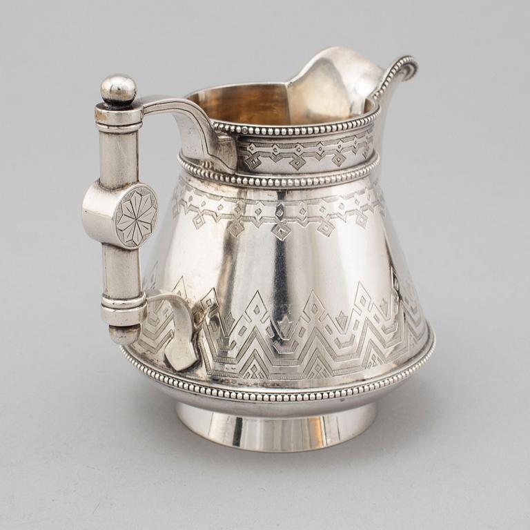 A Russian 19th century parcel-gilt silver tea pot and cream jug, mark possbly of Alexander Lokin, St. Petersburg 1893.