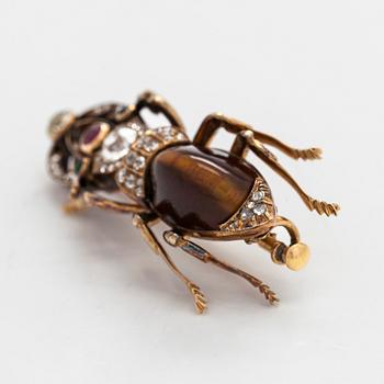 A 14K gold brooch with tiger’s eye, old-cut and rose-cut diamonds, ruby, emeralds. St. Petersburg.
