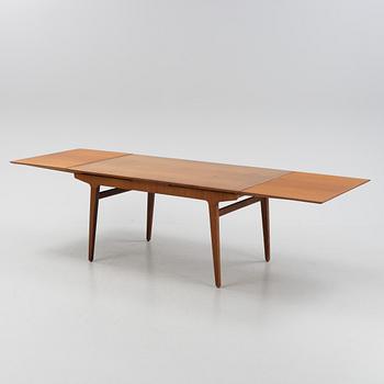 A 1960s teak veneer dining table.