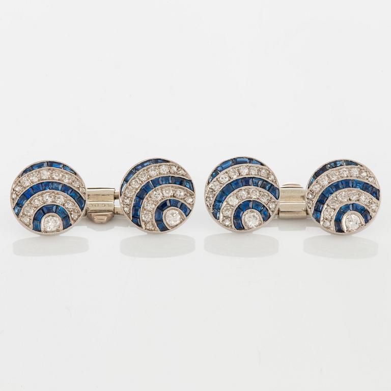 A pair of cufflinks in platinum and 18K white gold set with diamonds of various cuts and sapphires.