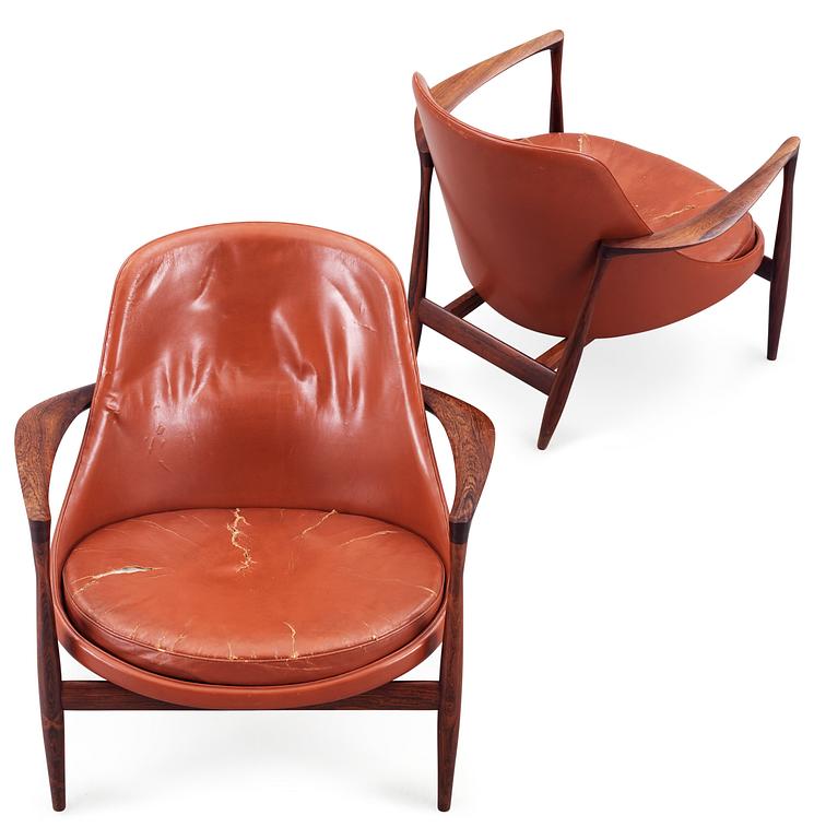 A pair of Ib Kofod Larsen 'Elisabeth' palisander and brown leather easy chairs.