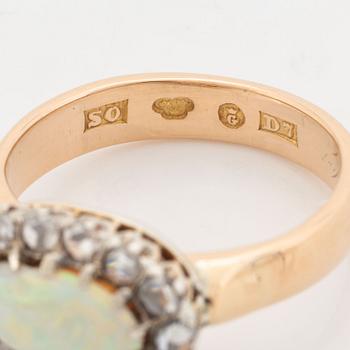 An 18K gold and opal ring set with rose-cut diamonds.