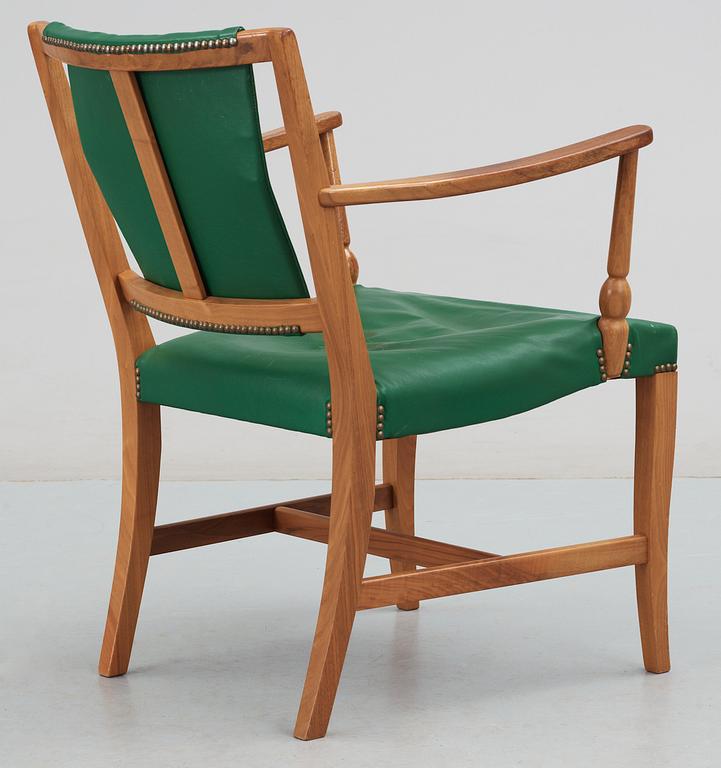 A Josef Frank mahogany and green leather armchair.
