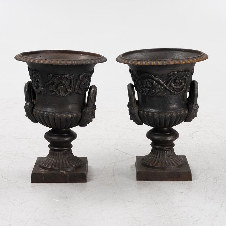 A pair of cast-iron planters, 20th century.