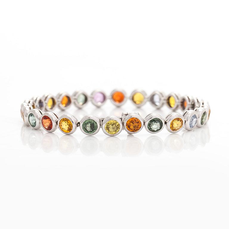 An 18K white gold bracelet, set with multicoloured sapphires.