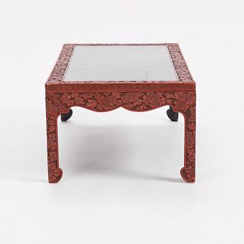 A carved lacquered table, early 20th Century.