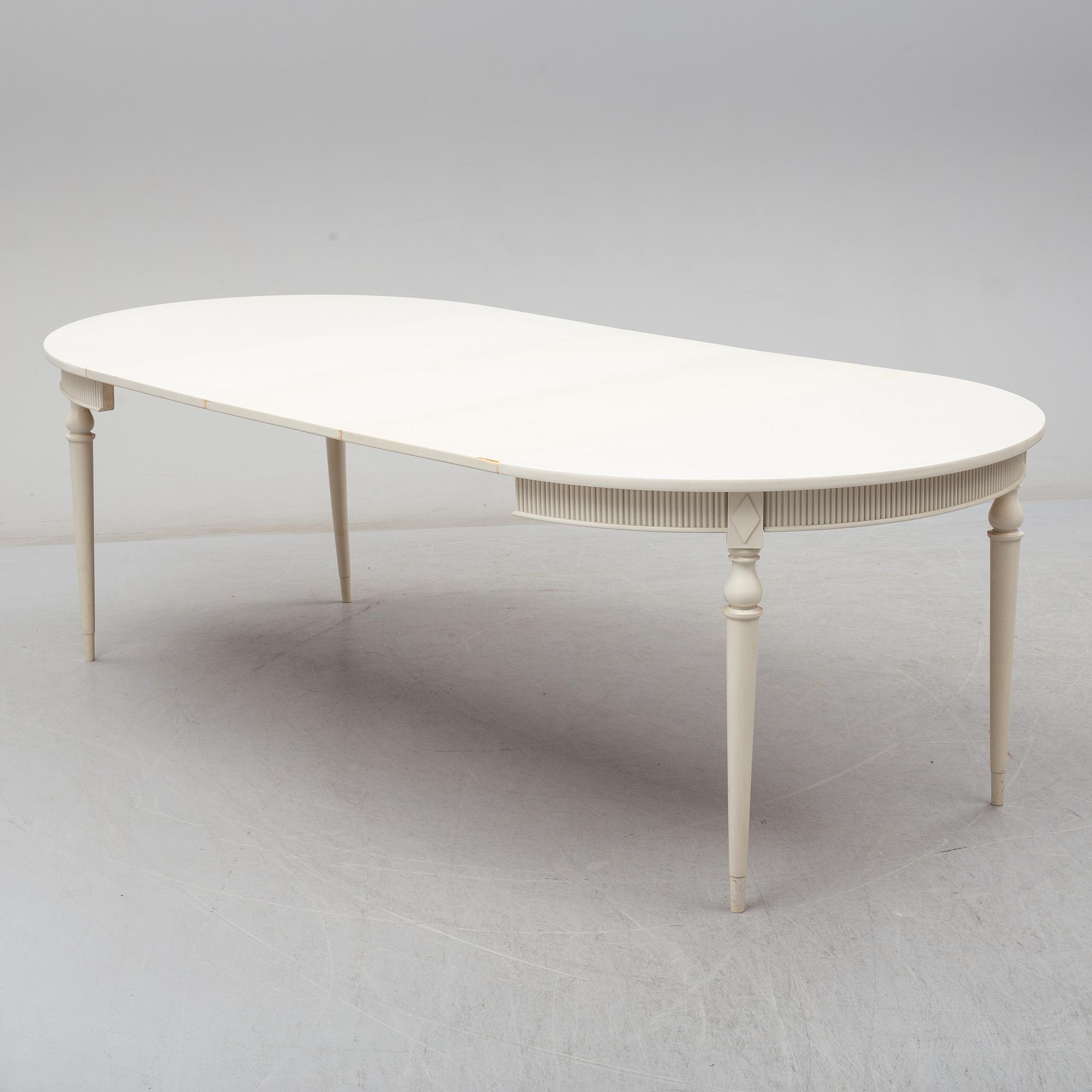 Four chairs with dinner table, late 20th Century.