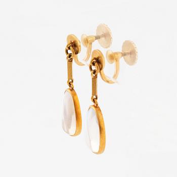 Wiwen Nilsson, a pair of 18K gold earrings set with cabochon-cut moonstones, Lund 1947.