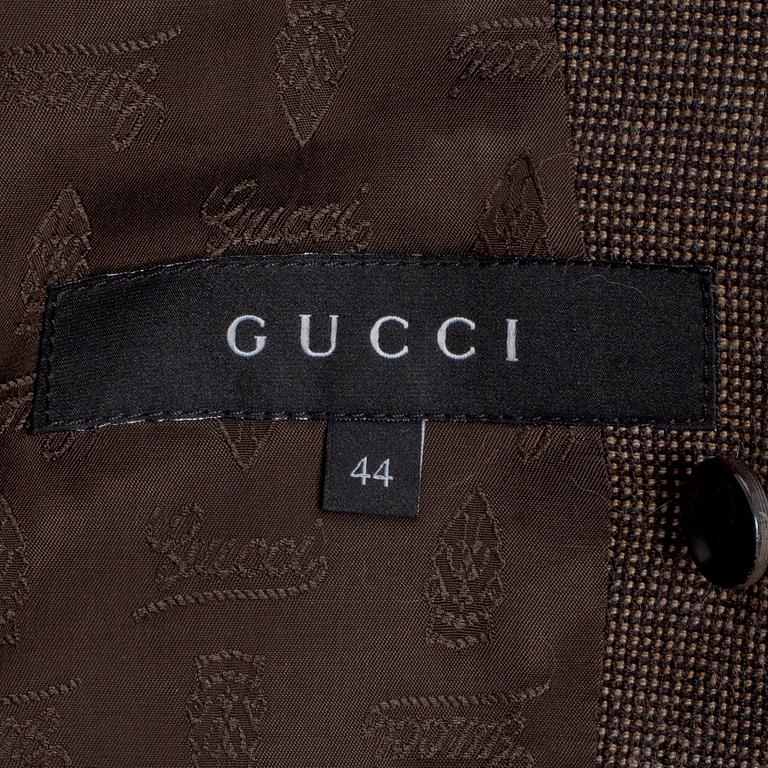 GUCCI, a two-piece suit consisting of jacket and pants.