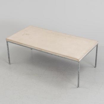 A modern sofa table with concrete top and steel legs.