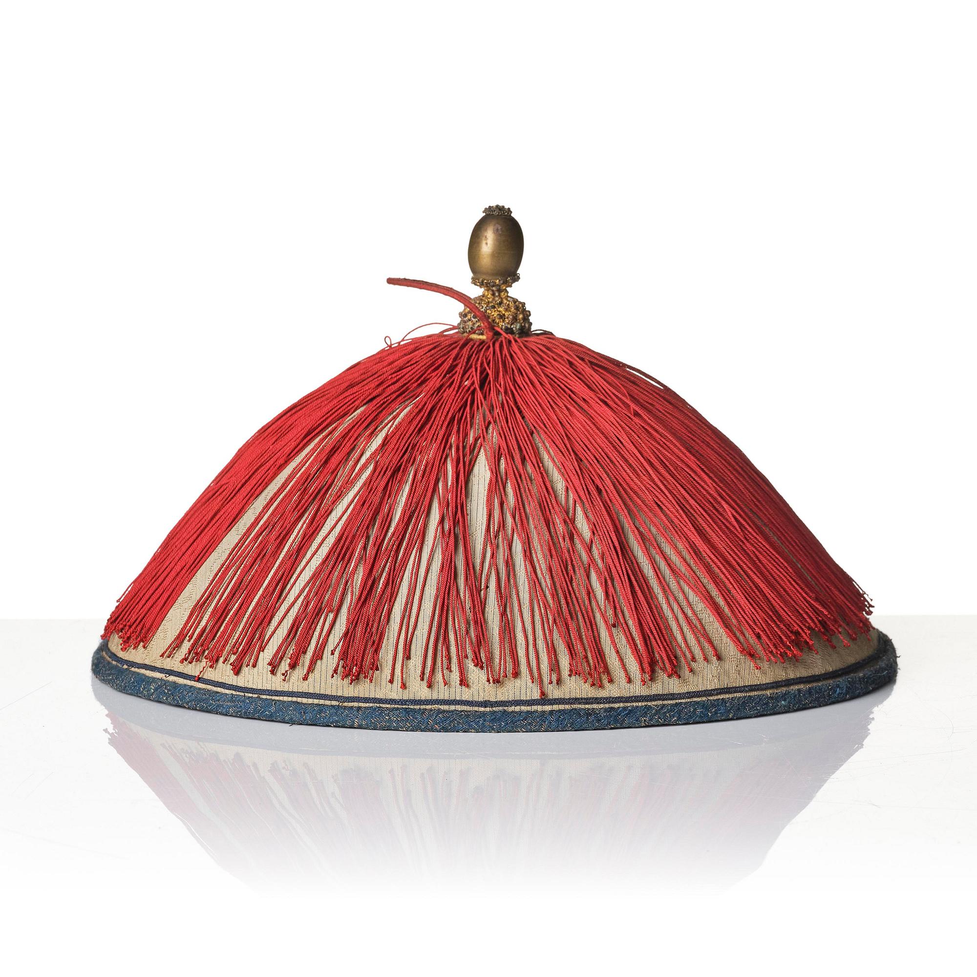 Two boxes with a mandarin's summer hat and black satin autumn hat and feather with six mandarin hat insignias.