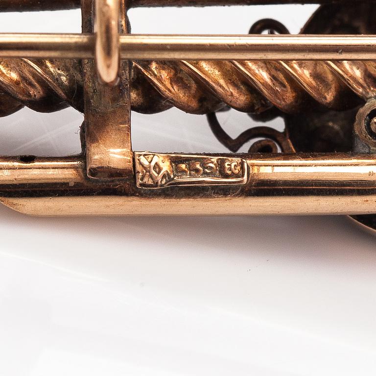 A 14K gold brooch with pearls and garnet glass doublet.