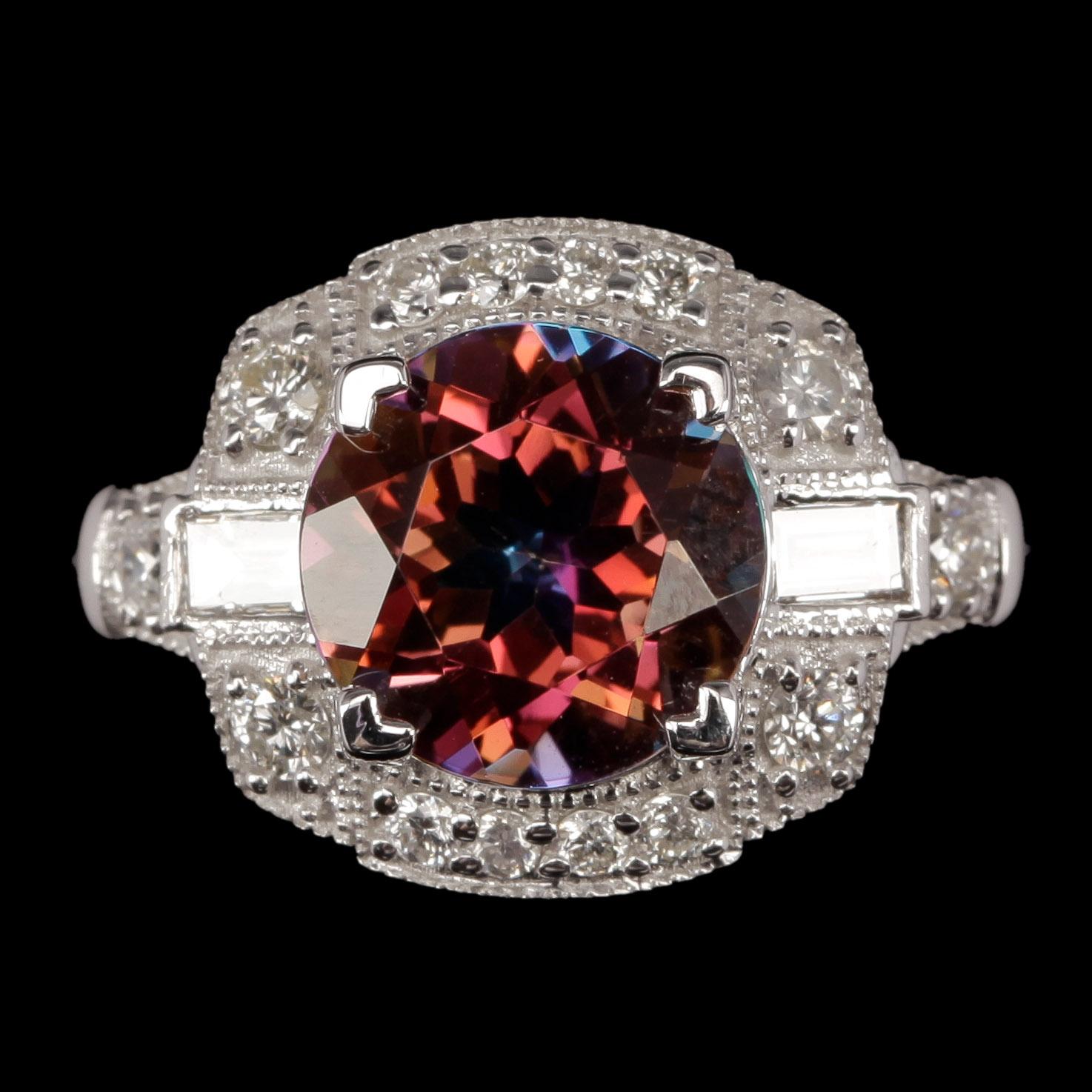 RING, 14k vitguld med "mystisk" topas ca 3,22 ct och briljantslipade diamanter. Vikt ca 4,4 gram.
