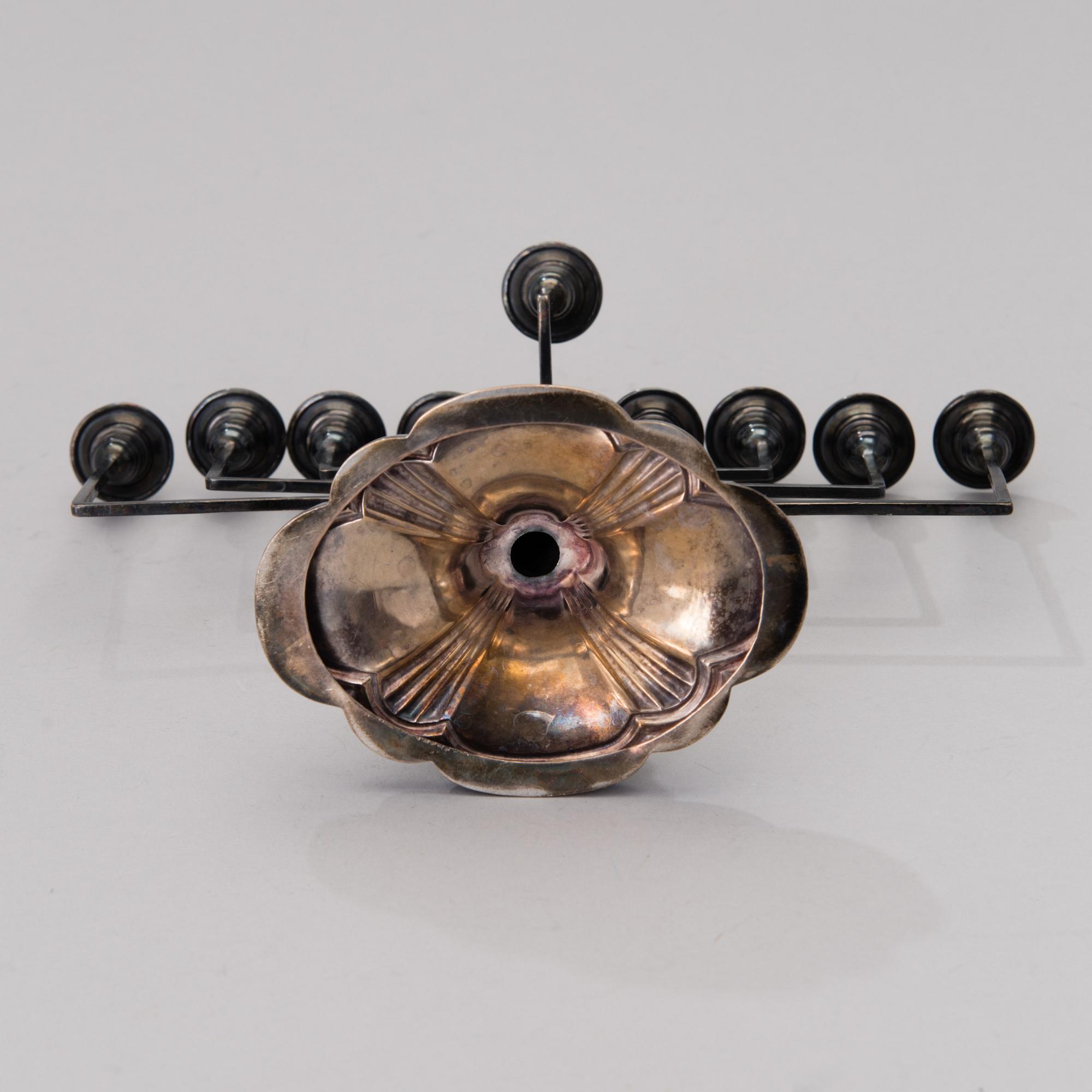 A chanukiah / menorah silver candelabrum for nine candles, mark of Britton, Gould & Co, Birmingham 1933.
